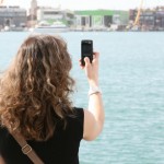 Girl with mobile phone using the camera