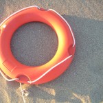 life preserver sitting on the beach